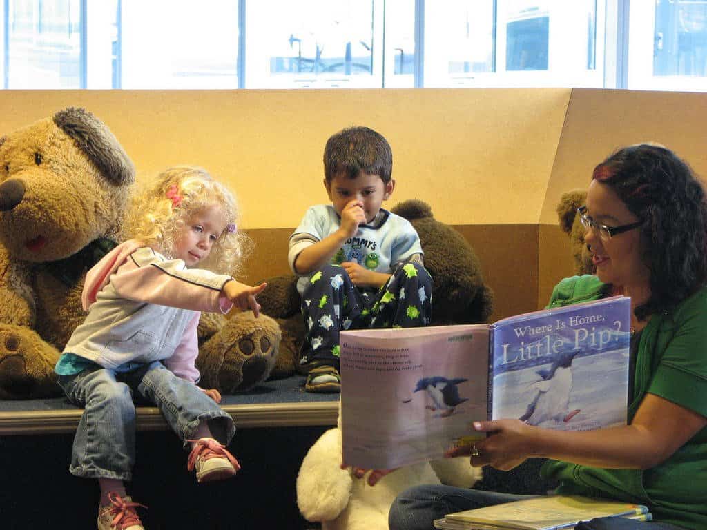 A group of stuffed animals sitting next to a man