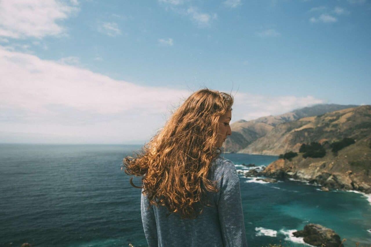 A person standing in front of a body of water