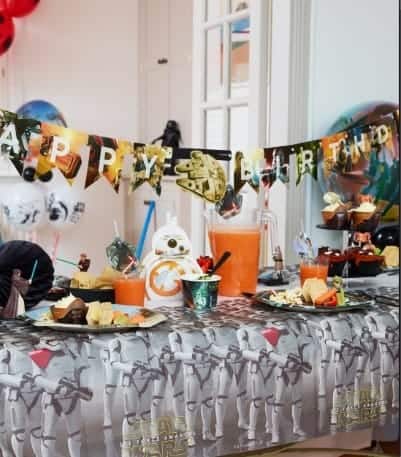 A group of people in a room with many items on the counter