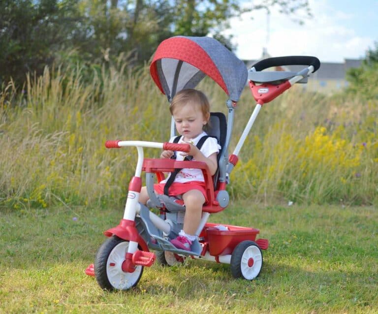 A young child riding on top of a grass covered field