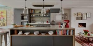 A room filled with furniture and vase of flowers on a kitchen counter