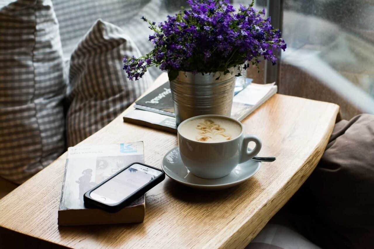 A cup of coffee sitting on top of a wooden table