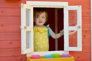 A little girl standing in front of a door