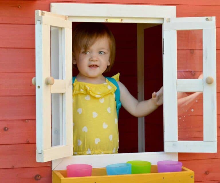 A little girl standing in front of a door