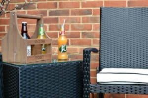 A chair sitting in front of a brick wall