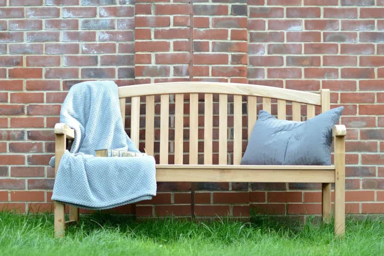 A chair sitting in front of a brick wall