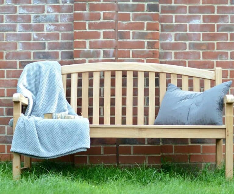 A chair sitting in front of a brick wall