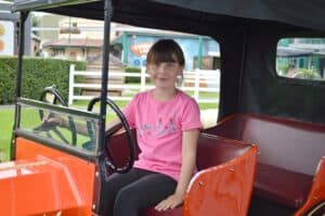 A little girl sitting on a bus