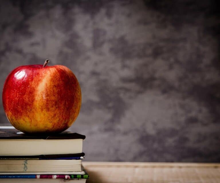 An apple sitting on top of a wooden table