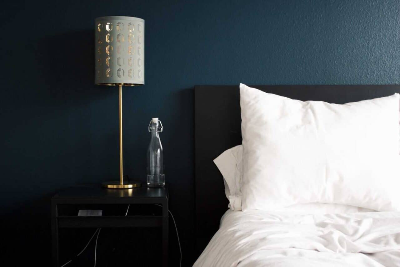 A lamp that is sitting on a bed