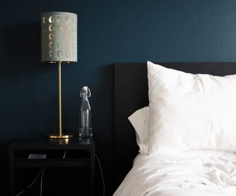 A lamp that is sitting on a bed