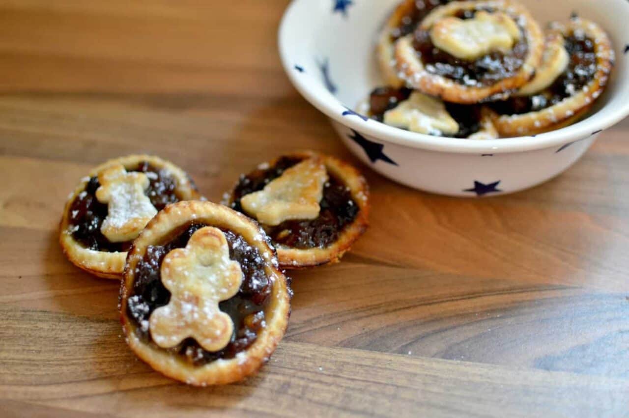 A bowl of food sitting on top of a wooden cutting board, with Pie