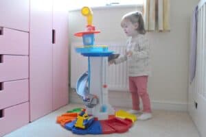 A little girl standing in front of a refrigerator