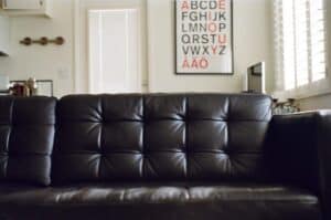 A brown leather couch in a living room