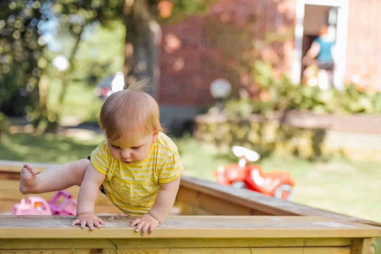 A little girl sitting at a picnic table