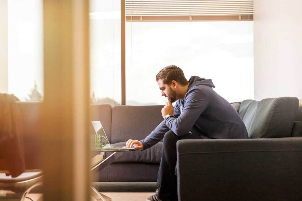 A man sitting in front of a window