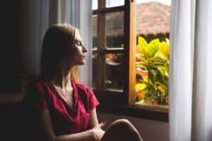 A woman standing in front of a window