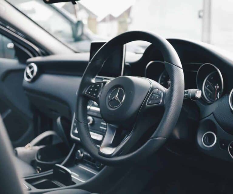 A car parked in front of a mirror