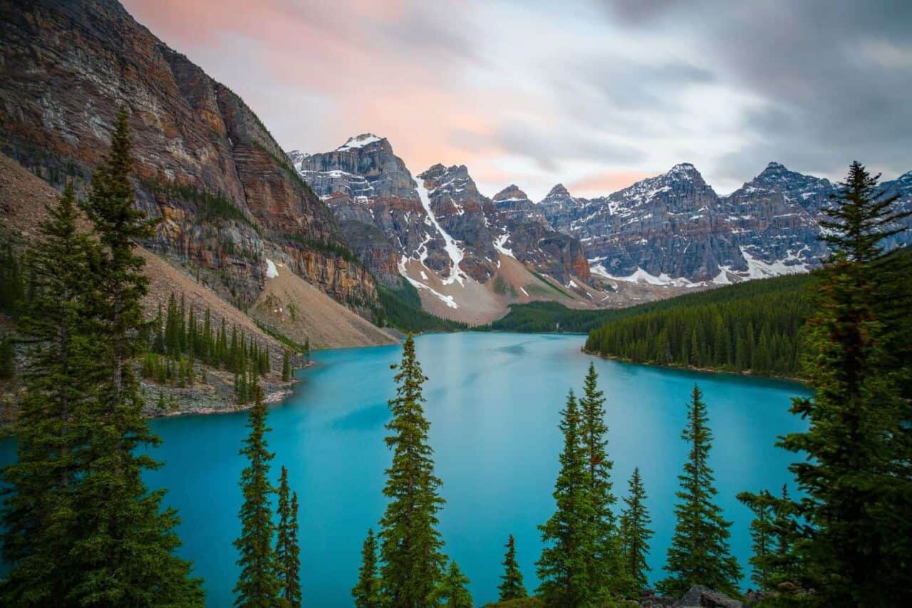 A view of Valley of the Ten Peaks surrounded by trees and a mountain in the background