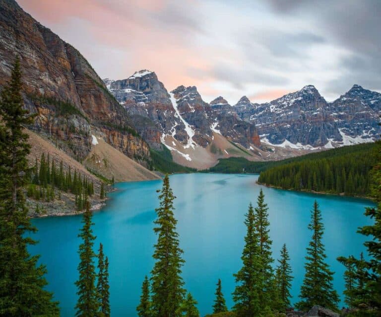 A view of Valley of the Ten Peaks surrounded by trees and a mountain in the background