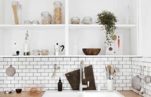 A kitchen with a sink and a mirror