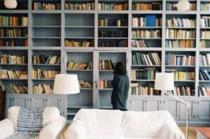 A room with a book shelf filled with books