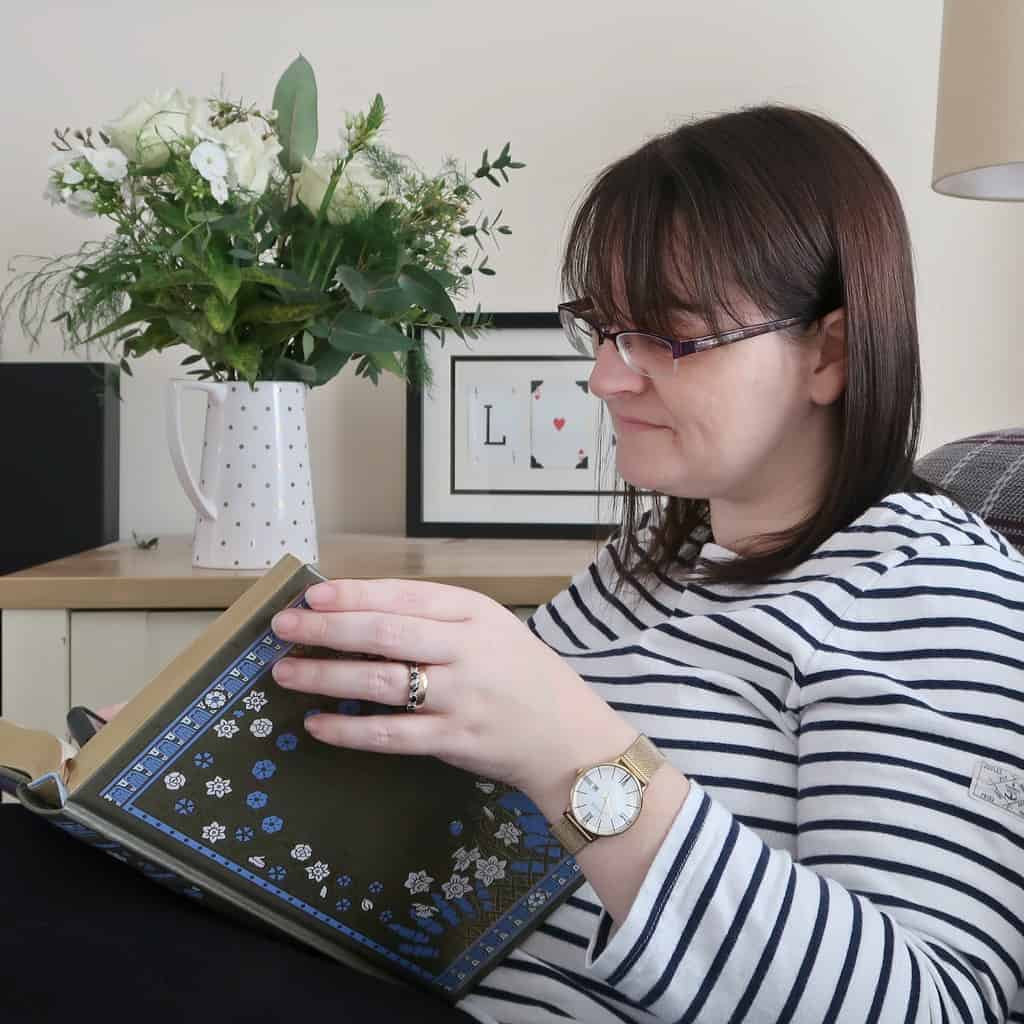 A woman sitting at a table using a laptop