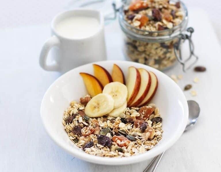 A bowl of fruit on a plate, with Calorie and Granola