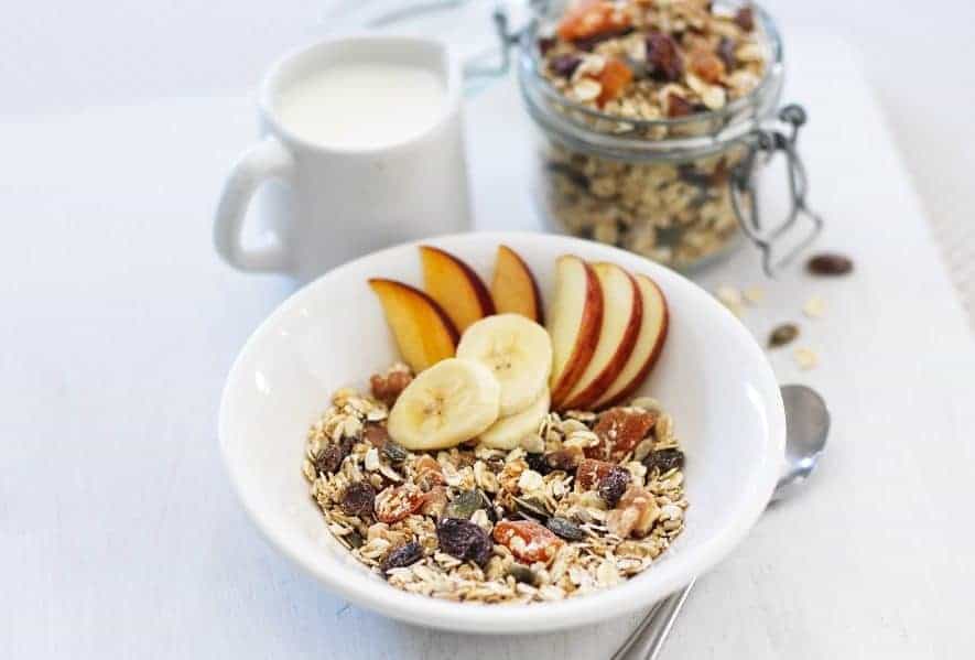 A bowl of fruit on a plate, with Calorie and Granola