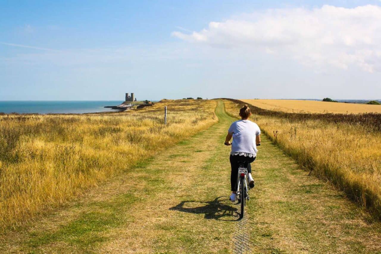 A person riding a bike down a dirt road