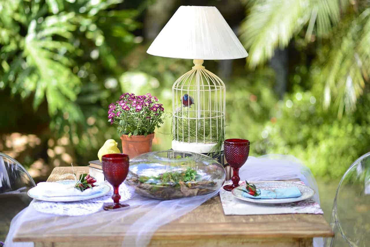 A glass of wine sitting on top of a picnic table, with Wood