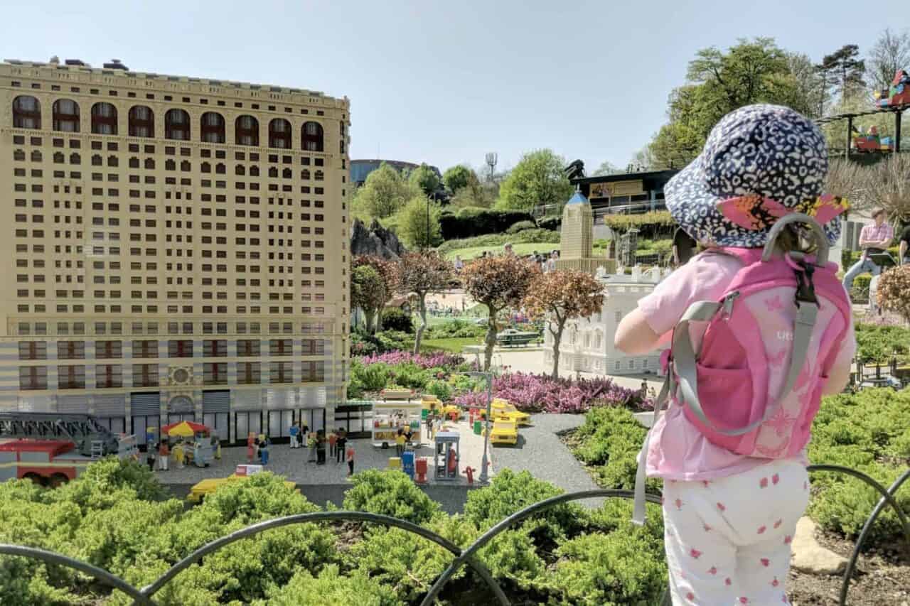 A little girl standing in front of a building