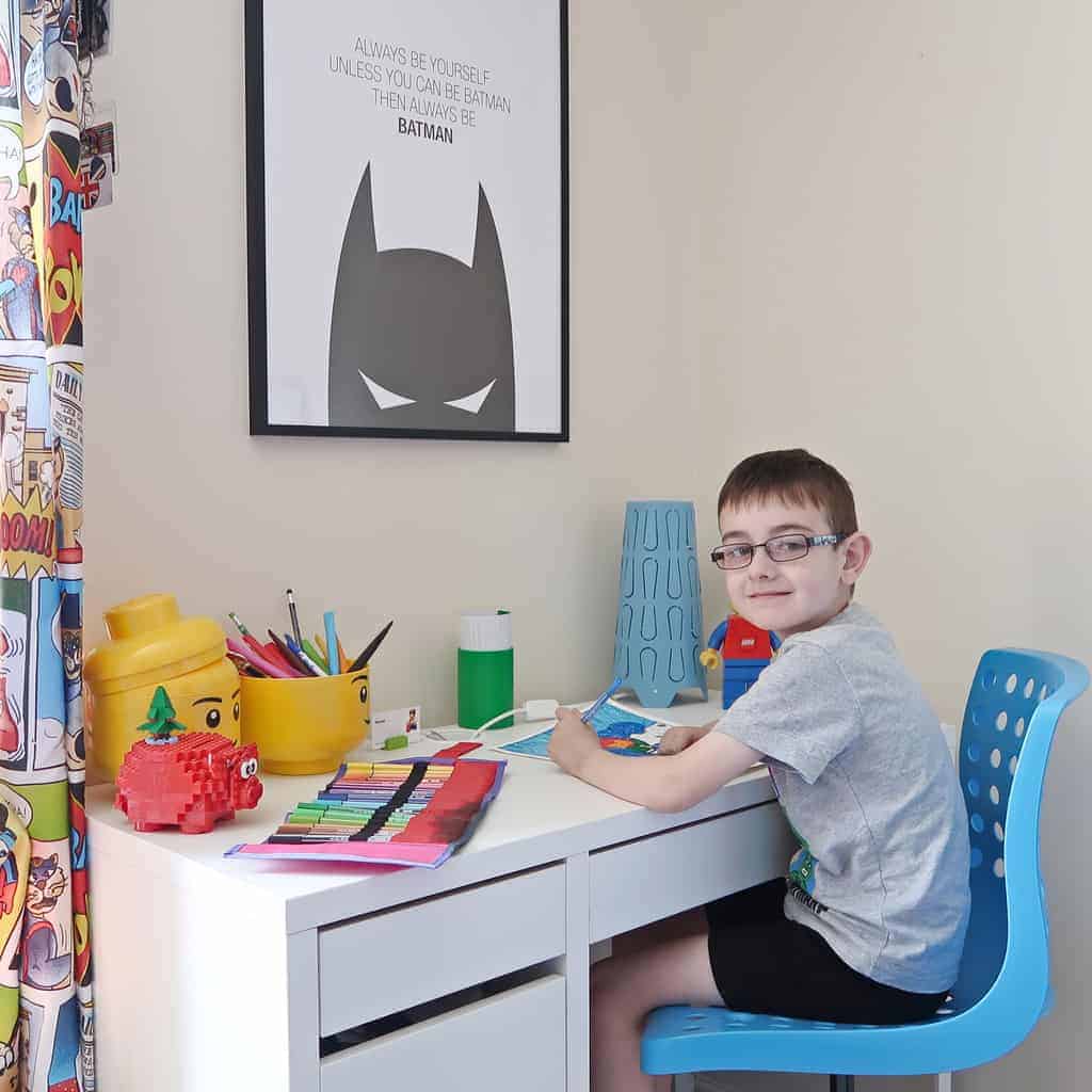 A young boy sitting at a table