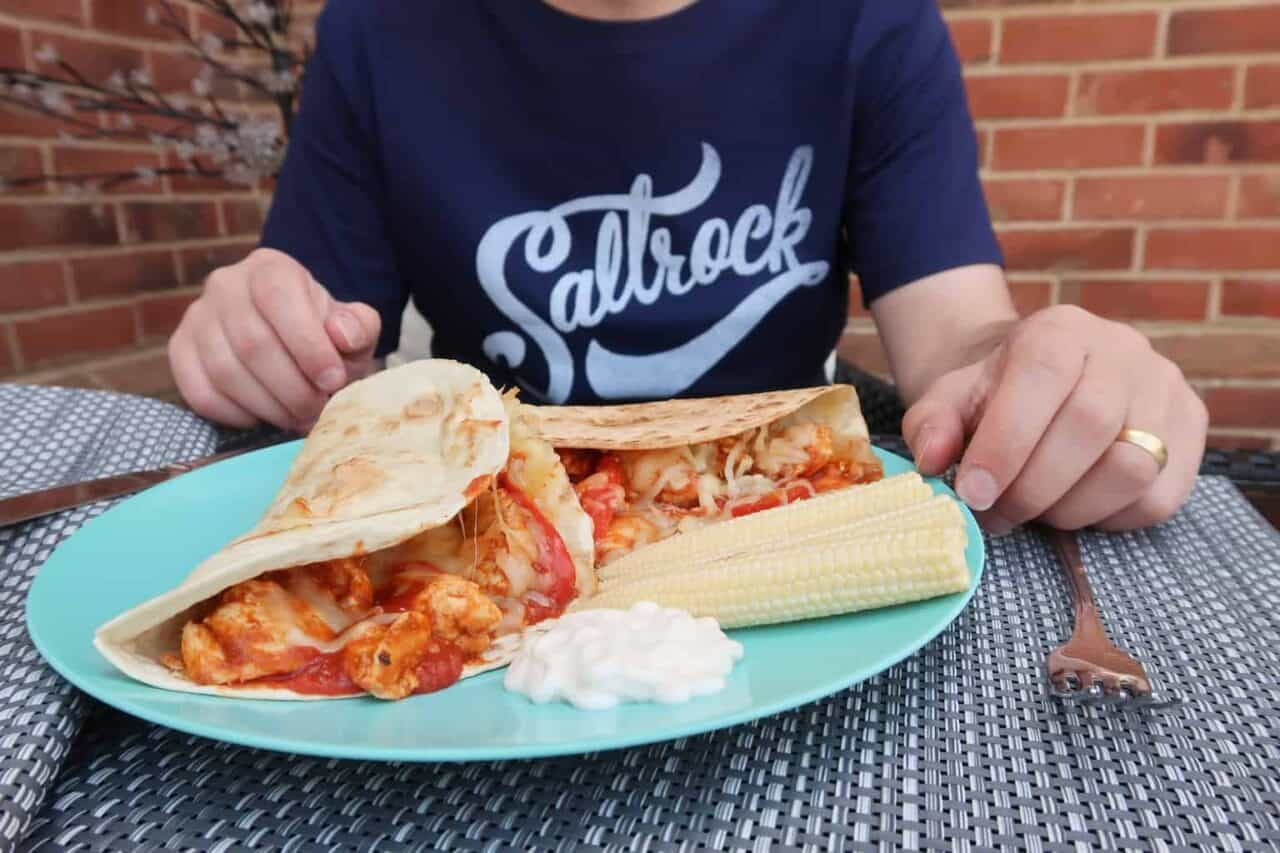 A person sitting at a table with a plate of food