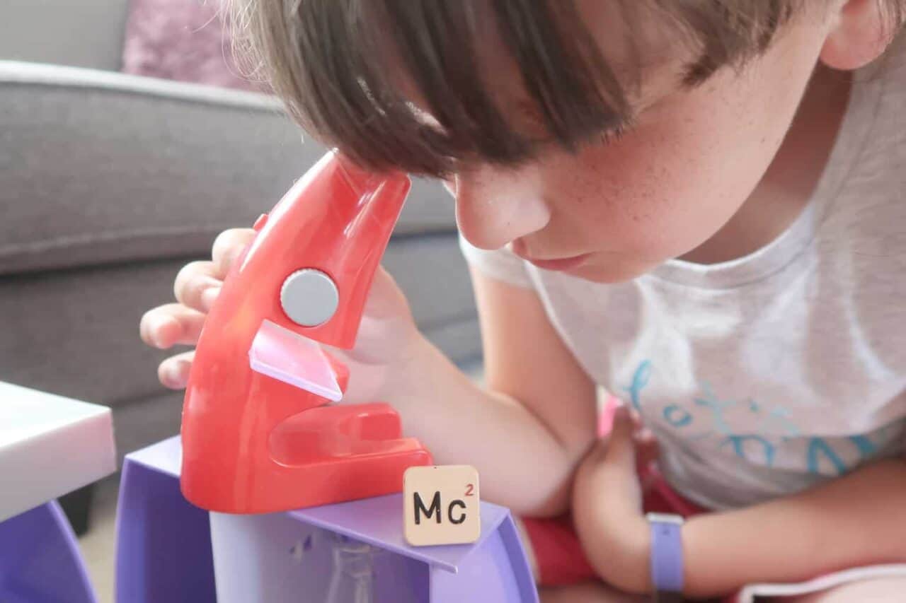 A close up of a small child sitting on a table