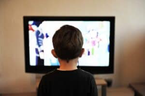 A man standing in front of a flat screen television