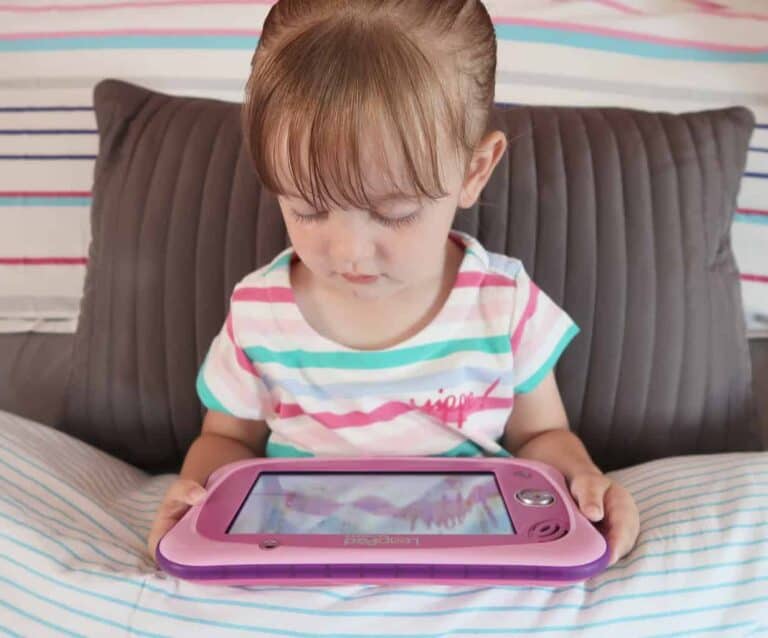 A small child sitting on a bed