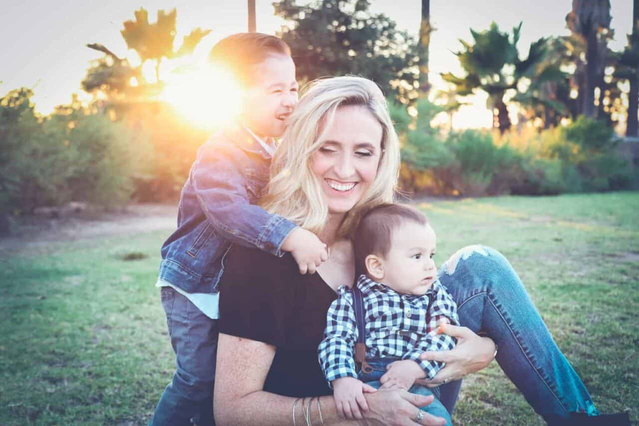 A person holding a baby in a park