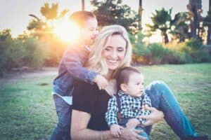 A person holding a baby in a park