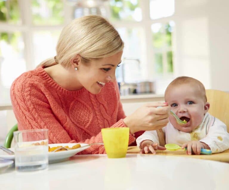 A little girl sitting at a table eating food