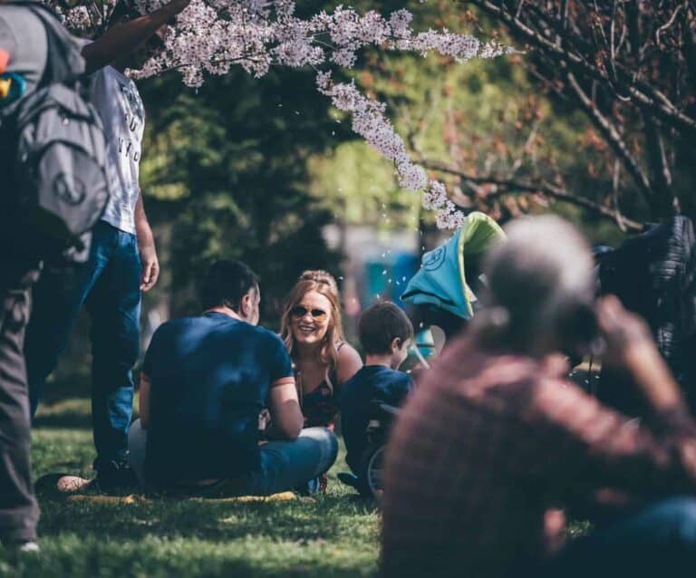 A group of people that are standing in the grass