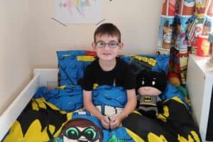 A young boy sitting on a table