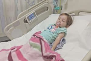 A little girl lying on a bed