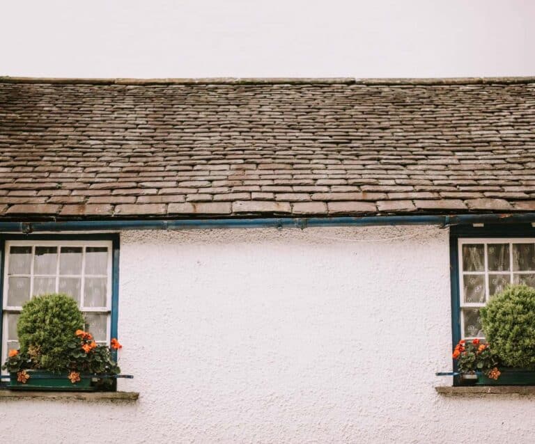 A house with bushes in front of a building