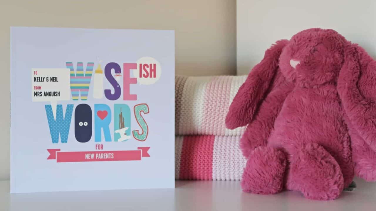 A pink teddy bear sitting on a table