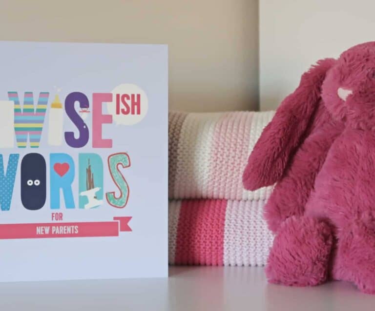 A pink teddy bear sitting on a table