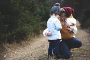 A little boy that is standing in the grass