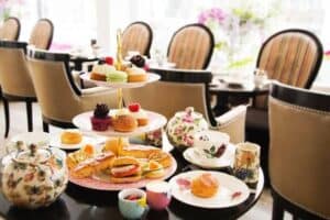 A dining table with a plate of food, with Tea