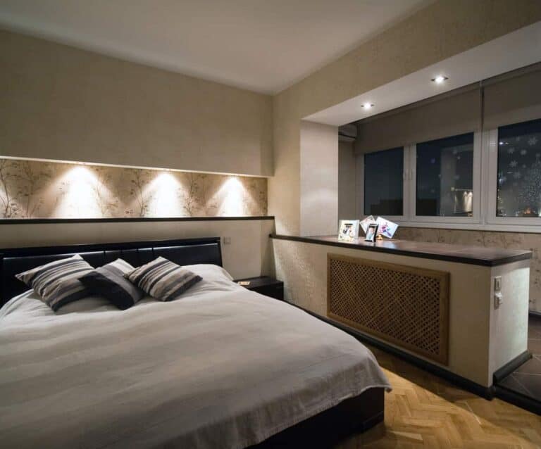 A bedroom with a large bed in a room