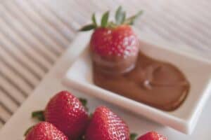 A cake with fruit on a plate, with Chocolate